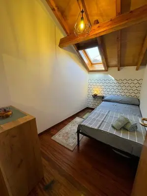 a bedroom with a bed in a room with a ceiling at La casa Azul in Allariz