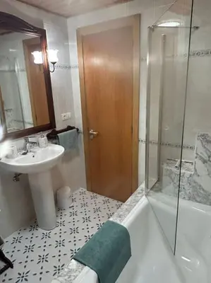 a bathroom with a tub and a sink and a shower at La casa Azul in Allariz