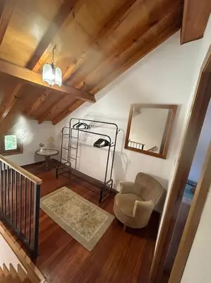 a living room with a chair and a mirror at La casa Azul in Allariz