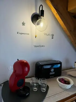 a red blender sitting on a counter with glasses at La casa Azul in Allariz