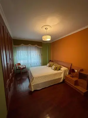 a bedroom with a large bed in a room at Piso de tres habitaciones frente al Puerto Deportivo in Viveiro