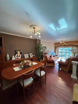 a living room with a wooden table and a dining room at Piso de tres habitaciones frente al Puerto Deportivo in Viveiro
