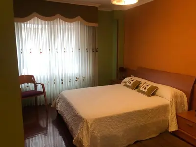 a bedroom with a bed with two pillows on it at Piso de tres habitaciones frente al Puerto Deportivo in Viveiro