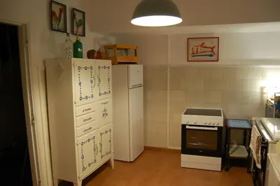 a kitchen with a refrigerator and a stove at A Casa do Buxo in Casardeita