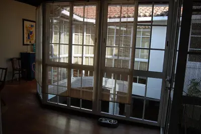 a room with a large window with blinds on it at A Casa do Buxo in Casardeita