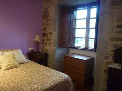 a kitchen with a table and a couch in a room at Apartamento Tránsito de Entrerruas in Santiago de Compostela