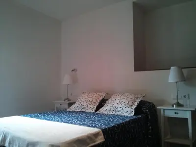 a bedroom with two beds with red pillows at Apartamento Tránsito de Entrerruas in Santiago de Compostela