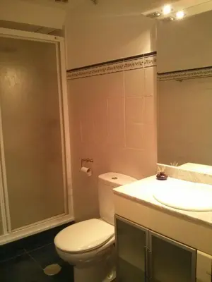 a kitchen with blue cabinets and a white microwave at Apartamento Tránsito de Entrerruas in Santiago de Compostela