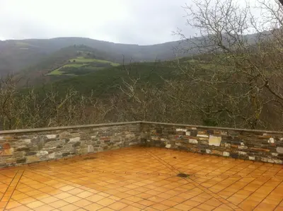 a patio with a view of a mountain at El Urogallo in Noceda