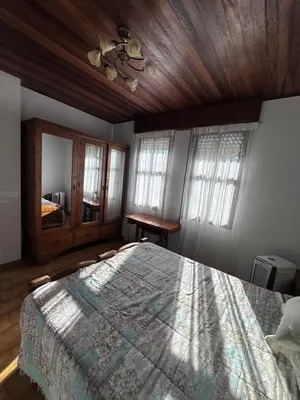a bedroom with a large bed with a wooden ceiling at Casa Lugar de Fidalgo in Vilamor