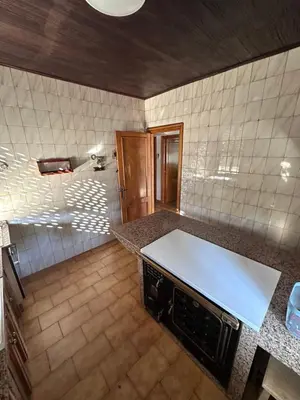 a kitchen with a white counter top in a room at Casa Lugar de Fidalgo in Vilamor