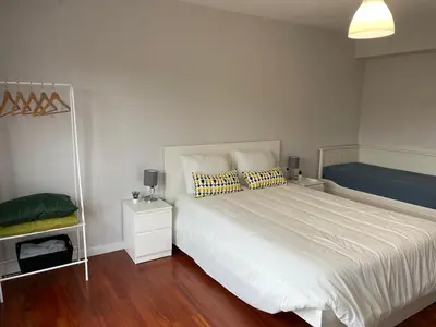 a bedroom with a large white bed and a mirror at Casa Pilar Primero in Sigüeiro