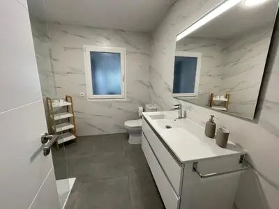 a bathroom with a sink and a toilet and a mirror at Casa Pilar Primero in Sigüeiro