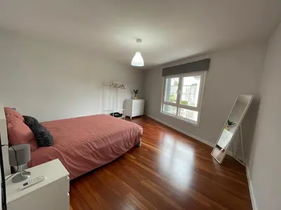 a bedroom with a bed and a large window at Casa Pilar Primero in Sigüeiro