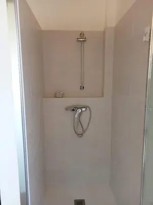 a bathroom with a shower with a shower head at Mini Room Ron in Merou