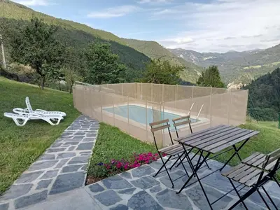 a picnic table and chairs next to a swimming pool at Mini Room Ron in Merou