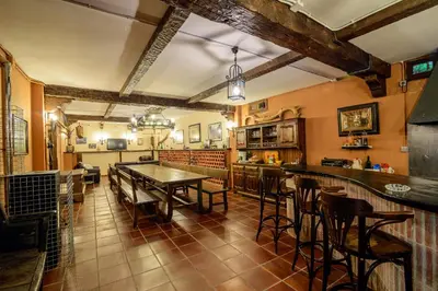 a kitchen with a table and chairs in a room at Hostal El Palacio in Molinaseca