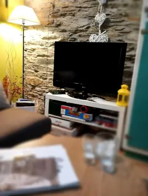 a flat screen tv sitting on top of a table at Refugio Alto Sil in Páramo del Sil