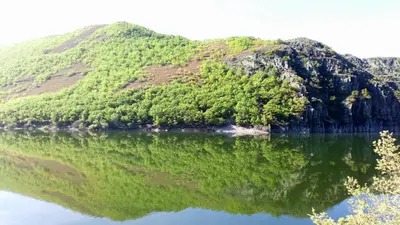 an island in the middle of a body of water at Refugio Alto Sil in Páramo del Sil