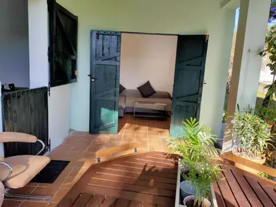 a living room with an open door and a couch at Casa de Josiño in Villamateo