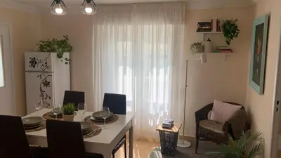 a living room with a table and a chair at O Pisiño in Ourense