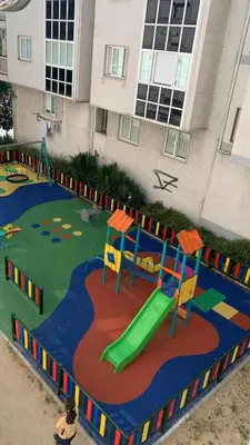 a playground in front of a building at O Pisiño in Ourense