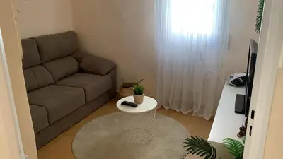 a living room with a couch and a table at O Pisiño in Ourense