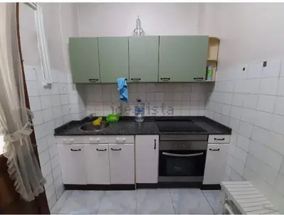 a small kitchen with a sink and a stove at Don Xesús in Ourense