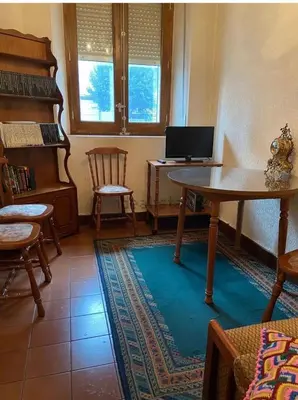 a room with a table and chairs and a desk at Don Xesús in Ourense