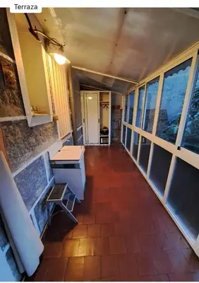 a hallway with a table and a bench in a room at Don Xesús in Ourense