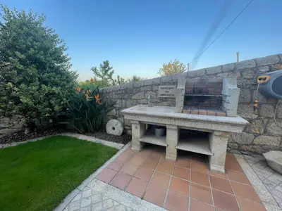 a stone bench sitting next to a stone wall at Apartamentos Río Sil in Sober