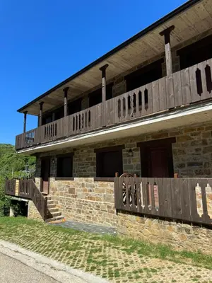 a building with a deck on top of it at Apartamentos Sanabria in Galende