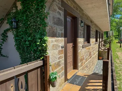 an entrance to a building with a door and ivy at Apartamentos Sanabria in Galende
