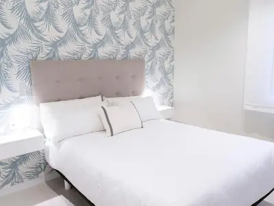 a white bed with white pillows in a bedroom at Loft América 32-0 in Melide