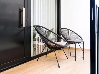 two chairs sitting in front of a door at Loft América 32-0 in Melide