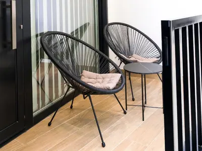 two chairs sitting next to each other on a balcony at Loft América 32-0 in Melide