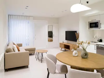 a living room with a table and a kitchen at Loft América 32-0 in Melide