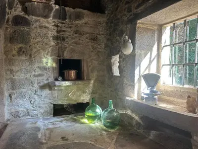two green glass vases sitting on a window sill at Casa do Bidueiro in Luou