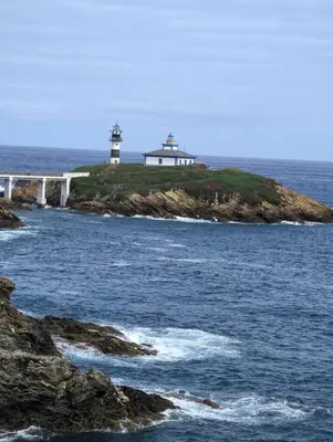 two lighthouses on an island in the ocean at Casa Muralla in Ribadeo