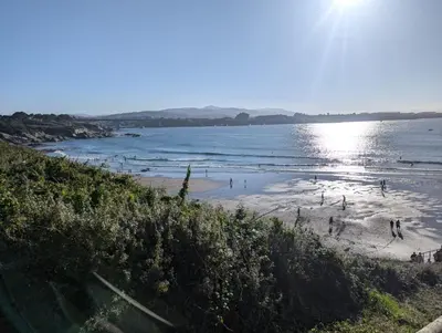 a beach with a group of people in the water at Casa Muralla in Ribadeo