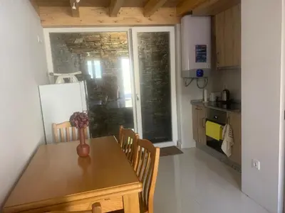 a kitchen with a wooden table with a vase on it at Casa Muralla in Ribadeo