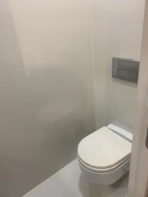 a bathroom with a white toilet in a stall at Casa Muralla in Ribadeo