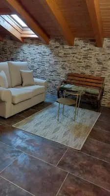 a living room with a couch and a bench at O Lar Do Bispo in Arbo
