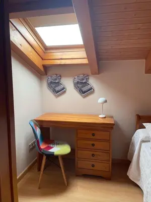 a bedroom with a desk and a bed and a window at O Lar Do Bispo in Arbo