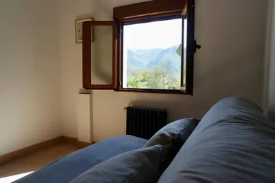 a living room with a couch and a window at Cainés in Villablino