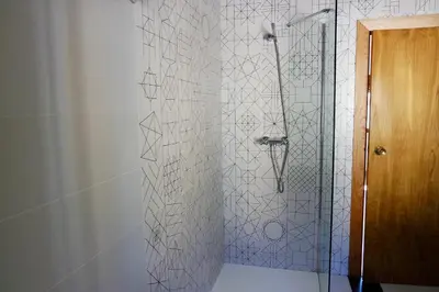 a bathroom with a shower with a glass door at Cainés in Villablino