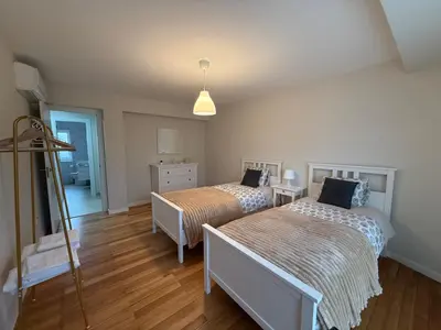 a bedroom with a bed and two dressers and a mirror at Casa Pilar segundo in Sigüeiro