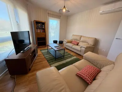 a living room with a couch and a tv at Casa Pilar segundo in Sigüeiro