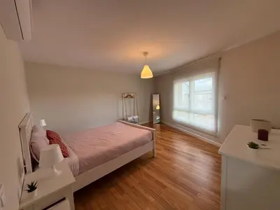 a bedroom with a bed and two night stands and a mirror at Casa Pilar segundo in Sigüeiro
