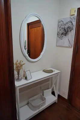 a bathroom with a white vanity and a mirror at O Ferrador in Caldas de Reis